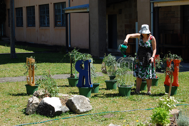 Artist and postgrad student Sarah with her "letters-plants" at TENDING, November 2010.
